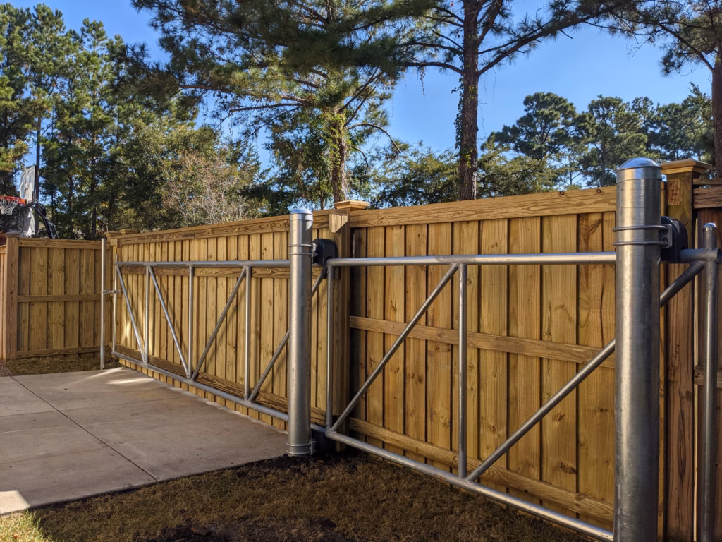 Cantilever slide gate with wood infill on a galvanized steel frame, built and hung by Two Brothers Fencing across a residential driveway